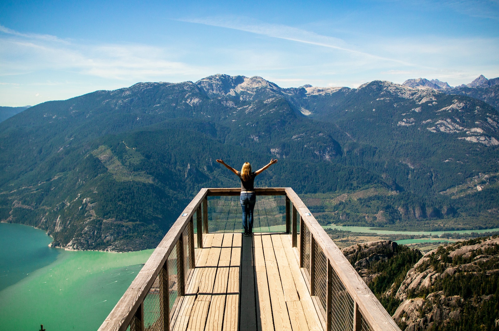 Person in Wooden Balcony Overlooking Mountains