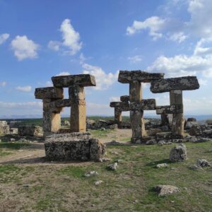 Explore ancient stone formations in Uşak, Türkiye under a bright blue sky.